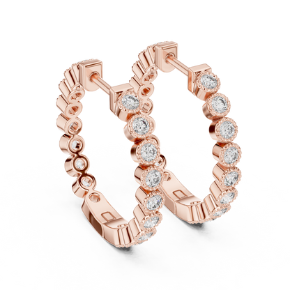 vintage-style round bezel-set diamond inside-out hoop earrings.  each hoop features a continuous line of individually bezel-set round brilliant-cut diamonds outlined with delicate milgrain beaded trim.